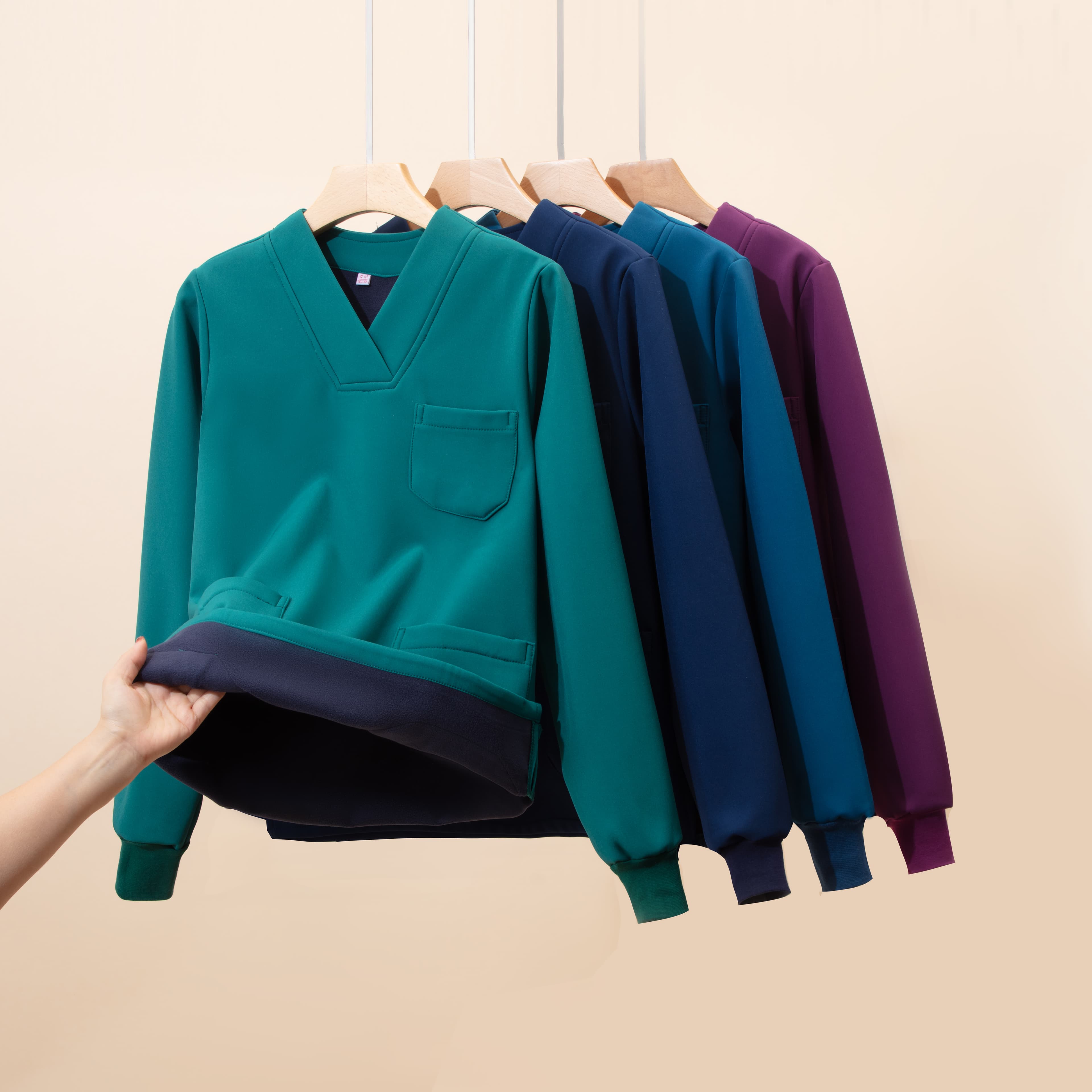 Long-sleeve scrub tops shown in several colors